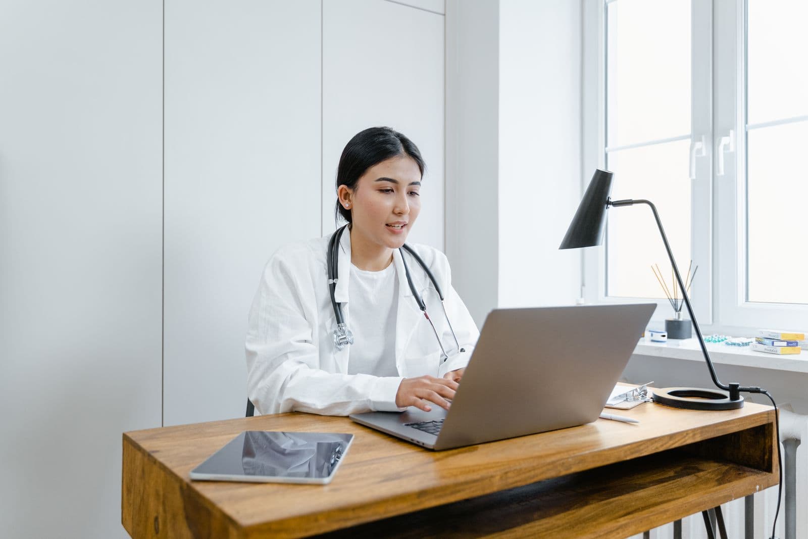 Physician reviewing collections growth on a laptop